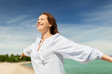 Image showing happy smiling woman on summer beach