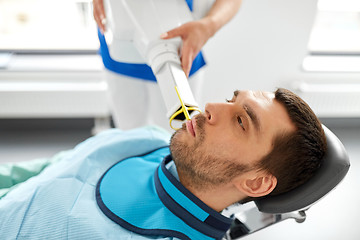 Image showing dentist making dental x-ray of patient teeth