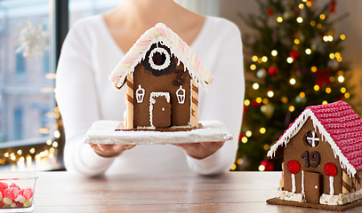 Image showing close up of woman with christmas gingerbread house