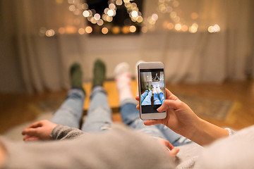 Image showing close up of couple taking foot photo by smartphone