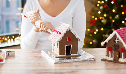 Image showing woman making gingerbread houses on christmas