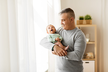 Image showing happy father holding with little baby son at home