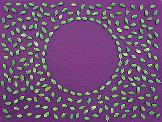 Image showing Pumpkin seeds frame on purple background