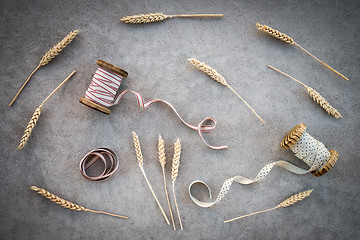 Image showing Wheat ears and vintage ribbon bobbins