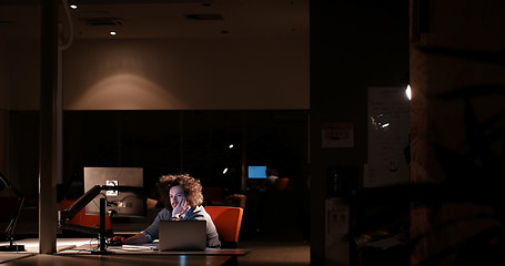 Image showing man working on computer in dark office