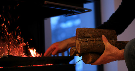 Image showing hands at fireplace making fire