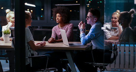 Image showing Multiethnic startup business team in night office