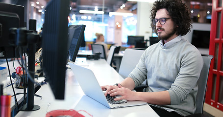 Image showing businessman working using a laptop in startup office