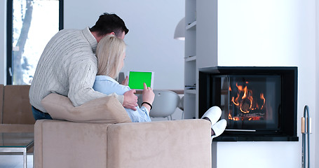 Image showing couple relaxing at  home with tablet computers