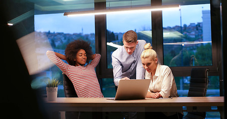 Image showing Multiethnic startup business team in night office