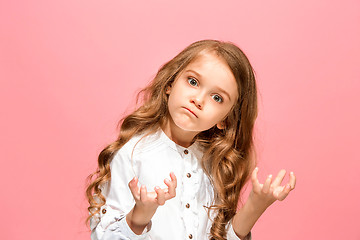 Image showing Portrait of angry teen girl on a pink studio background