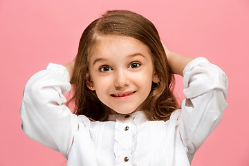 Image showing Beautiful teen girl looking suprised isolated on pink