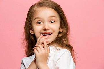 Image showing The happy teen girl standing and smiling against pink background.