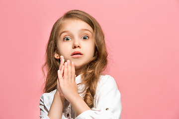 Image showing Beautiful teen girl looking suprised isolated on pink