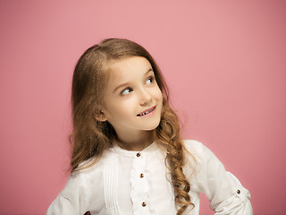 Image showing The happy teen girl standing and smiling against pink background.