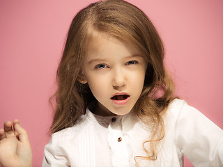 Image showing Portrait of angry teen girl on a pink studio background