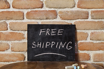 Image showing Black chalkboard with the phrase FREE SHIPPING drown by hand on 