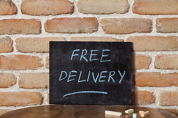 Image showing Black chalkboard with the phrase FREE DELIVERY drown by hand on 