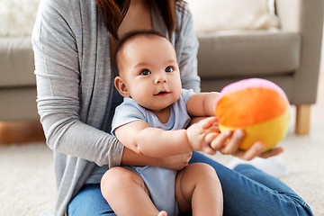 Image showing mother and baby son playing with ball at home