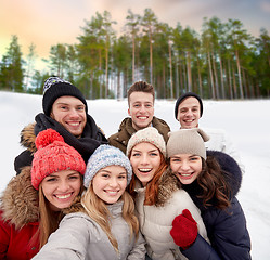 Image showing group of friends taking selfie outdoors in winter