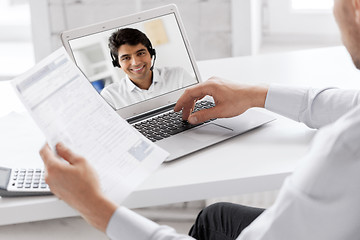 Image showing businessman having video call on laptop at office