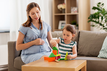 Image showing pregnant mother and daughter with toy blocks