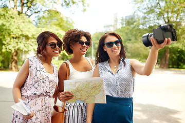 Image showing women with map travelling and recording video blog