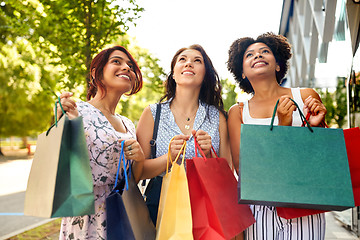 Image showing happy women with shopping bags in city