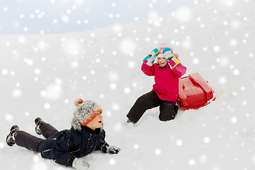 Image showing happy little kids with sled down hill in winter