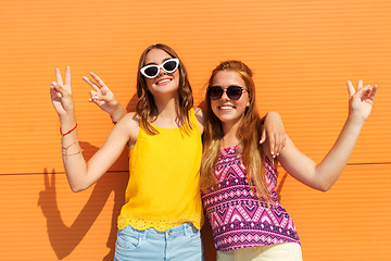 Image showing smiling teenage girls showing peace in summer