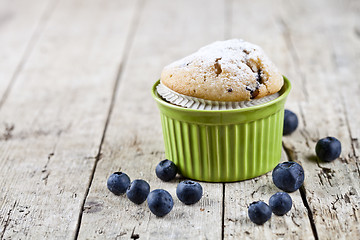 Image showing Homemade fresh muffin on ceramic green bowl with blueberries on 