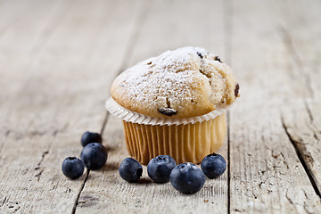 Image showing Fresh baked homemade muffin with sugar power and blueberries on 