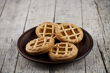 Image showing Fresh baked crostata with marmalade or apricot jam filling on br