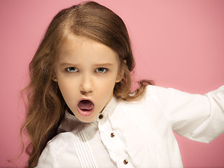 Image showing Portrait of angry teen girl on a pink studio background