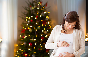 Image showing happy pregnant woman at home on christmas