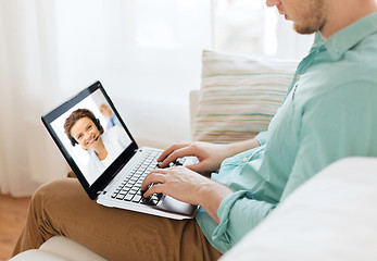 Image showing man having video call with helpline operator