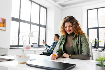 Image showing creative woman working on user interface at office