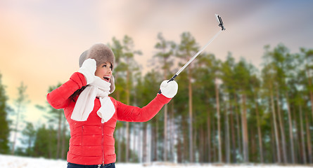 Image showing happy woman taking selfie over winter forest