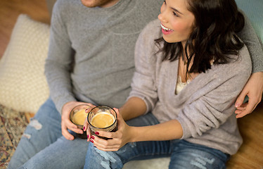 Image showing close up of happy couple drinking coffee at home