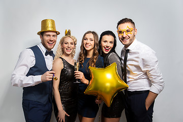 Image showing happy friends with golden party props posing