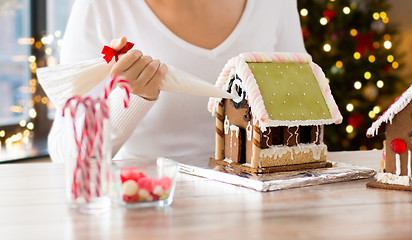 Image showing woman making gingerbread houses on christmas