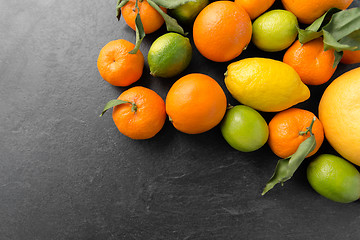 Image showing close up of citrus fruits on stone table