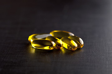 Image showing Omega-3 oil capsules and vitamin for health care on black board 