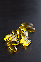 Image showing Omega-3 oil capsules and vitamin for health care on black board 