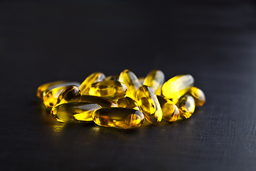 Image showing Omega-3 oil capsules and vitamin for health care on black board 