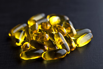 Image showing Omega-3 oil capsules and vitamin for health care on black board 