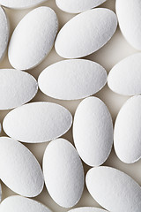 Image showing Pile of white drug pills laying on white background