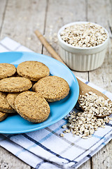 Image showing Fresh baked oat cookies on blue ceramic plate on linen napkin an