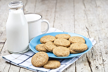 Image showing Fresh baked oat cookies on blue ceramic plate on linen napkin, b