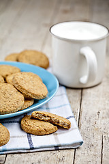 Image showing Fresh baked oat cookies on blue ceramic plate on linen napkin an